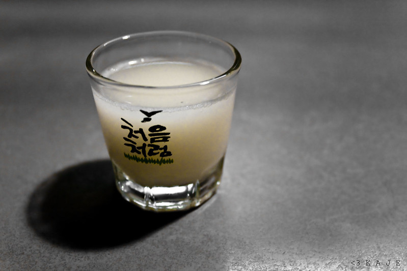 A shot glass filled with yogurt soju